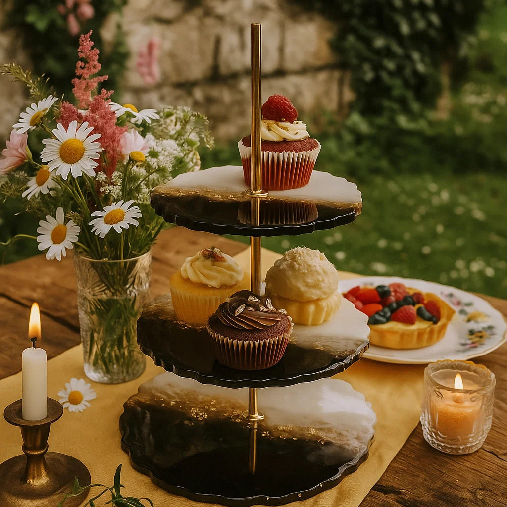 Three-tiered dessert stand with cupcakes and a vase of flowers on a wooden table, Cottage Core