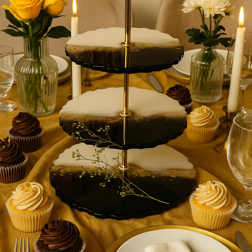 Three-tiered cake stand with cupcakes on a decorated table