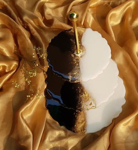 A black n white resin dessert stand on a satin table cloth