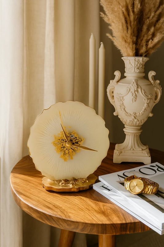 Decorative clock on a wooden table with a vase and magazine in the background