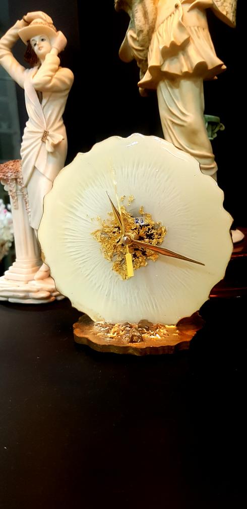 Decorative clock with gold accents on a dark background