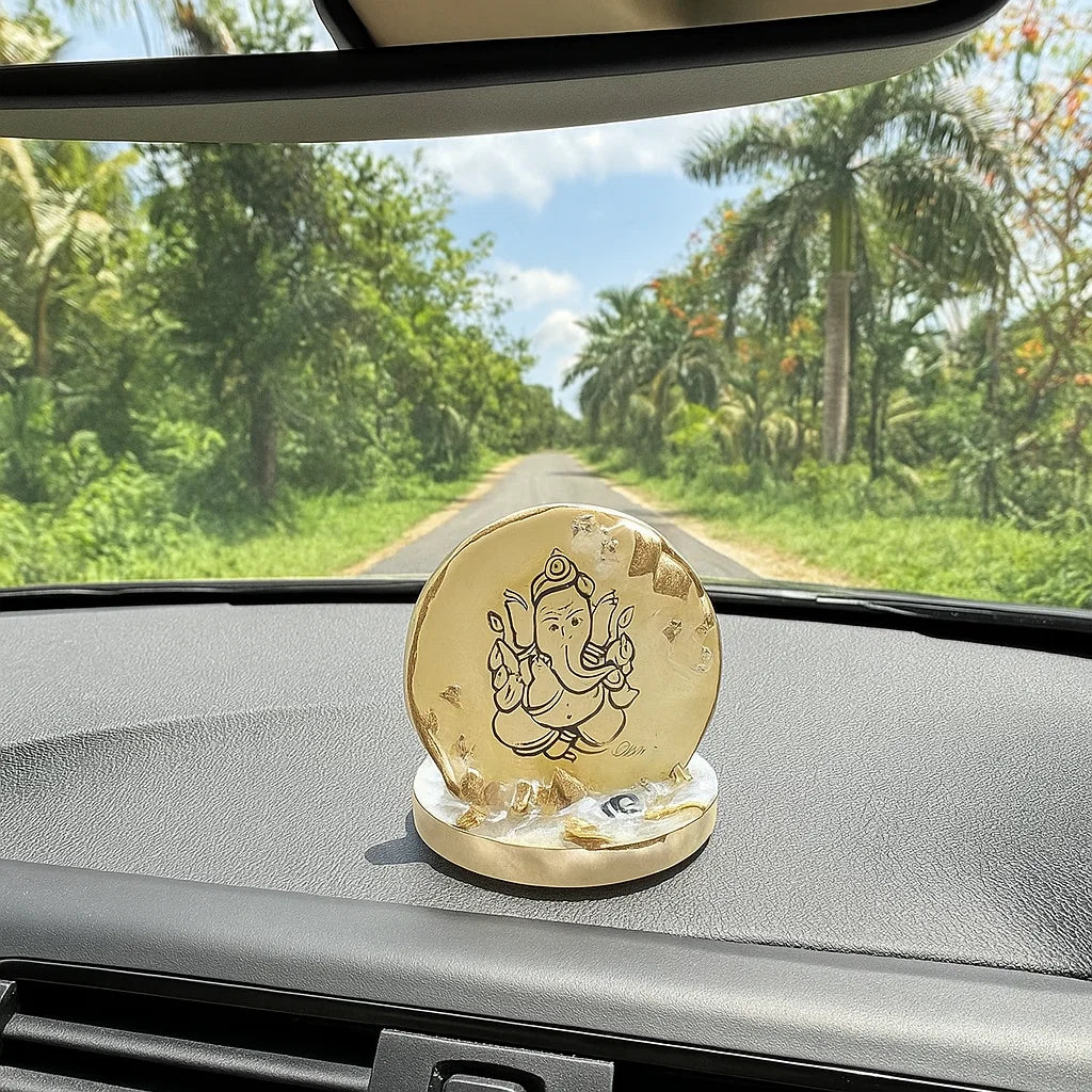 A Car dashpoard with a desorative ganesha figurine