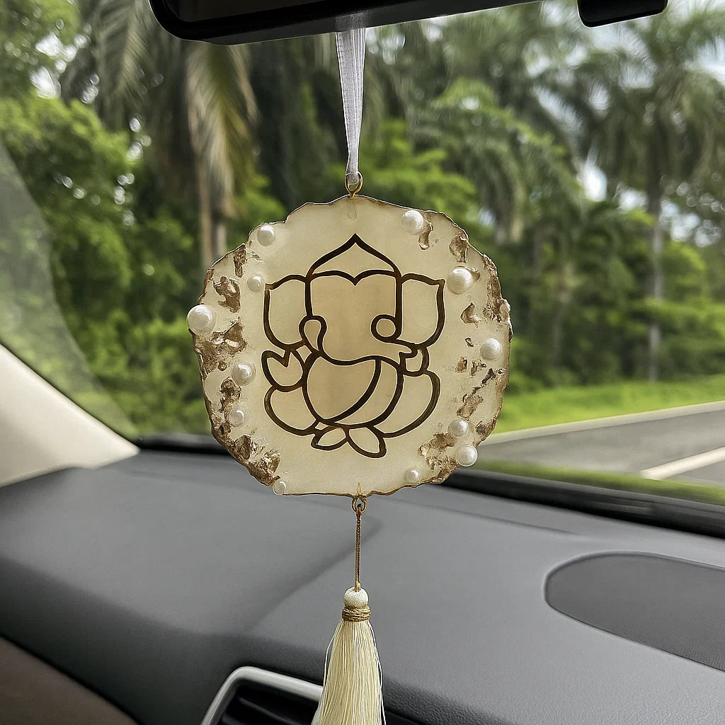 Decorative car hanging with Ganesha symbol on a car dashboard