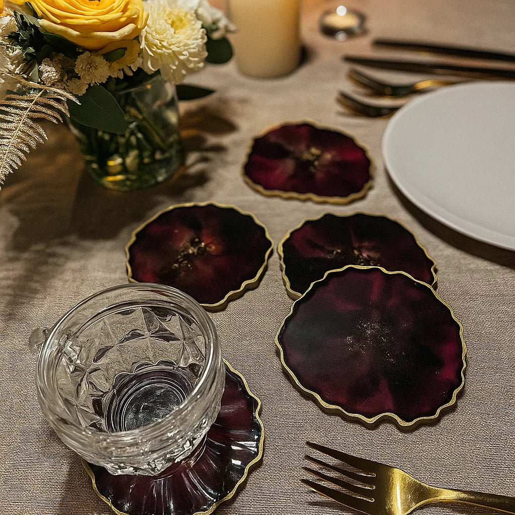 Wedding table setting with deep red coasters and florals 