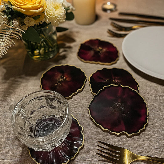 Wedding table setting with deep red coasters and florals 