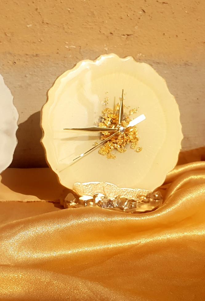 Decorative clock with gold accents on a textured surface